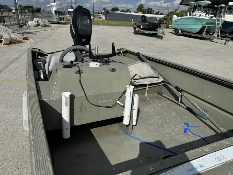 Slide: The Image of 2009 Lowe R1655SC boat with steering console, parked outdoors on a sunny day. - 5