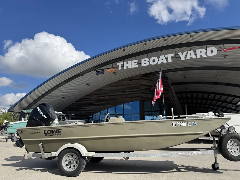Slide: The Image of 2009 Lowe R1655SC boat on trailer at The Boat Yard with American flag. - 7