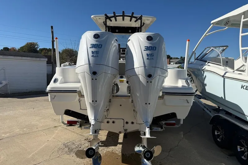 Slide: The Image of 2026 Key West 263 FS boat with dual 300 V6 outboard engines, docked outdoors. - 14
