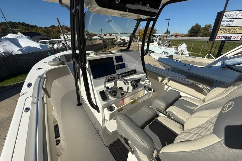 Slide: The Image of 2026 Key West 263 FS boat interior with modern helm and seating. - 16