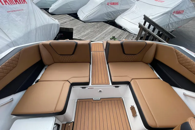 Slide: The Image of 2026 Yamaha 222SE boat interior with tan seating and wood accents. - 11