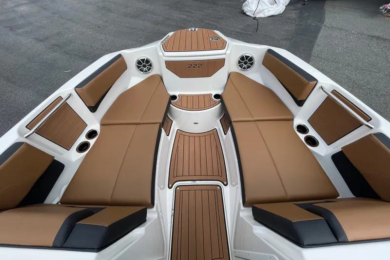 Slide: The Image of 2026 Yamaha 222SE boat interior with tan seating and wood accents. - 12