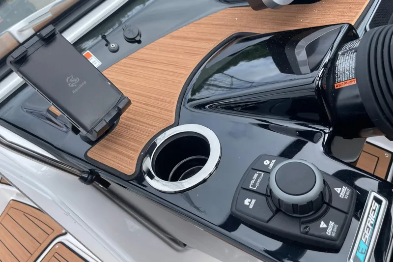 Slide: The Image of Control panel of 2026 Yamaha 222SE boat with phone holder and cup holder. - 17