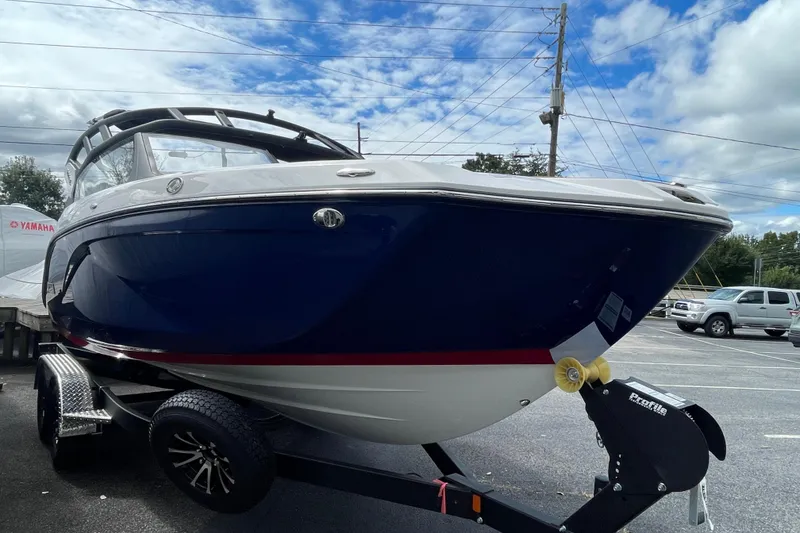 Slide: The Image of 2026 Yamaha 222SE boat on trailer under cloudy sky. - 2