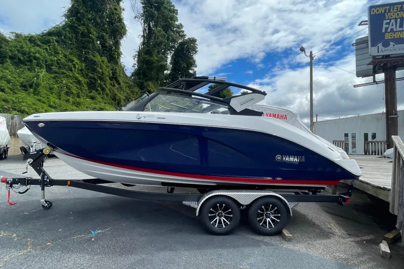 Slide: The Image of 2026 Yamaha 222SE boat on trailer, blue and white design, parked outdoors. - 4