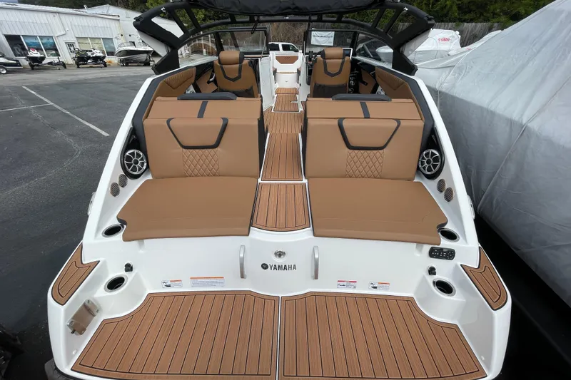 Slide: The Image of 2026 Yamaha 222SE boat interior with tan seating and wood accents. - 7