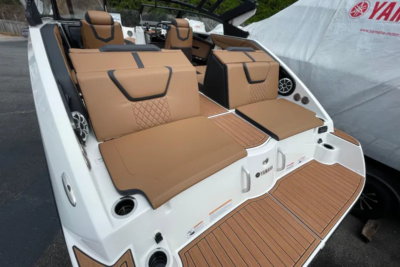 Slide: The Image of 2026 Yamaha 222SE boat with tan seating and sleek design, docked outdoors. - 8