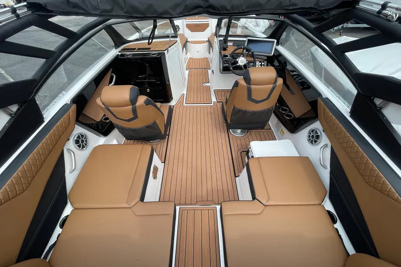 Slide: The Image of 2026 Yamaha 222SE boat interior with tan seating and sleek design. - 9