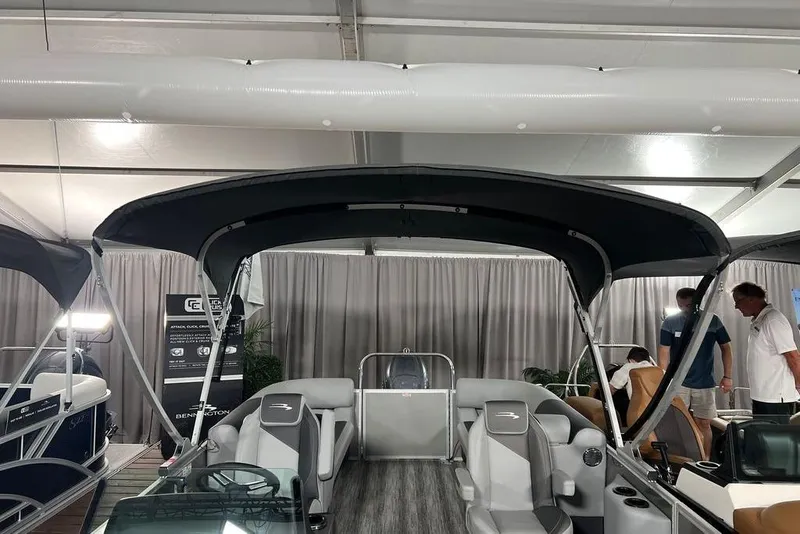 Slide: The Image of 2026 Bennington SSR boat interior with canopy, displayed indoors at an event. - 6