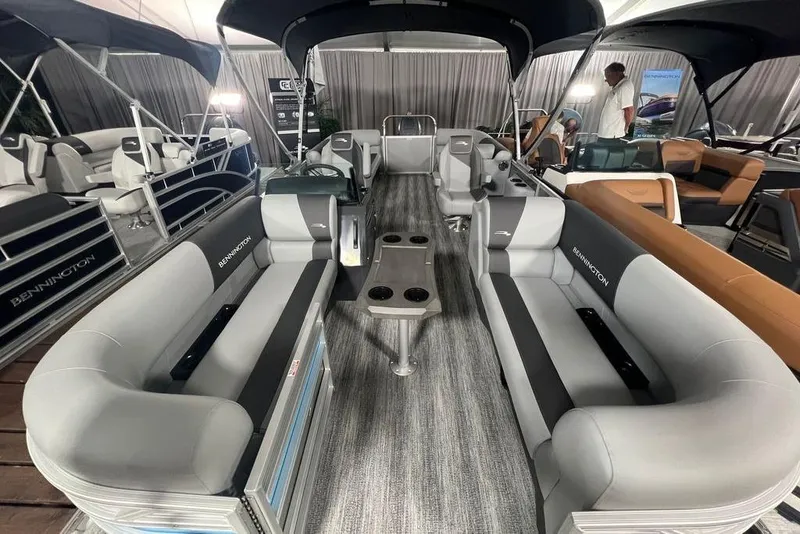 Slide: The Image of 2026 Bennington SSR pontoon boat interior with gray seating and table setup. - 7