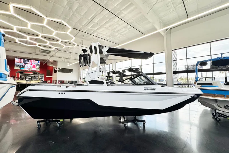 The Image of 2025 Nautique Super Air Nautique GS20 boat displayed in a modern showroom. - 1