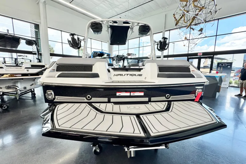 Slide: The Image of 2025 Nautique Super Air Nautique GS20 boat displayed in a modern showroom. - 4