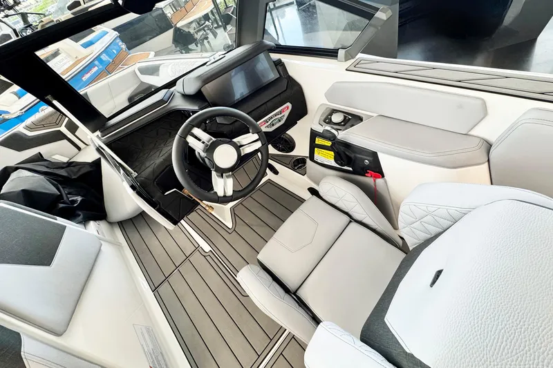 Slide: The Image of 2025 Nautique Super Air Nautique GS20 interior with modern dashboard and steering wheel. - 8