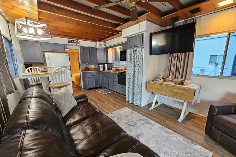 Slide: The Image of Interior of a 1985 Sumerset 14x60 houseboat with cozy living area and modern kitchen. - 10
