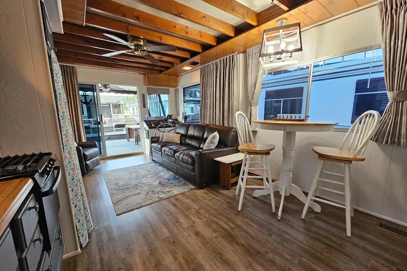 Slide: The Image of Interior of a 1985 Sumerset 14x60 houseboat with cozy seating and dining area. - 12