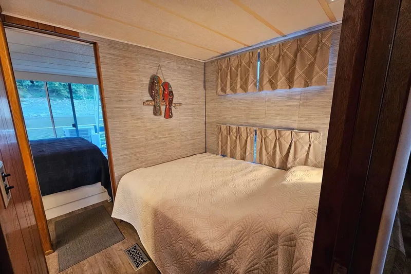 Slide: The Image of Cozy bedroom in 1985 Sumerset 14x60 houseboat with elegant decor and natural light. - 16