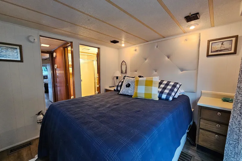 Slide: The Image of Cozy bedroom in a 1985 Sumerset 14x60 houseboat with stylish decor and comfortable bedding. - 19