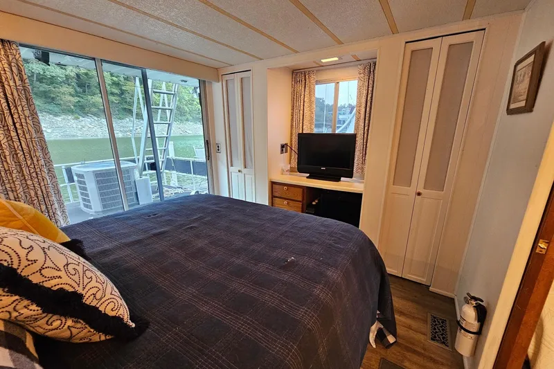 Slide: The Image of Cozy bedroom in 1985 Sumerset 14x60 houseboat with lake view and modern amenities. - 22