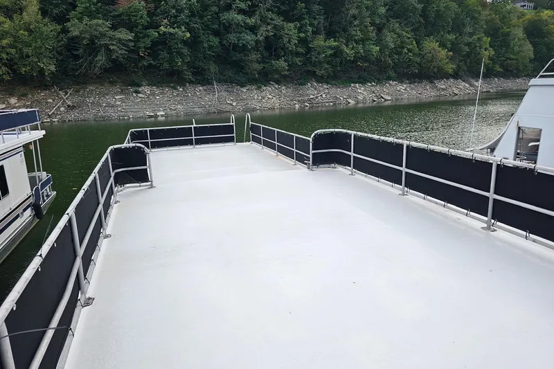 Slide: The Image of Rooftop deck of a 1985 Sumerset 14x60 houseboat on a serene river. - 31