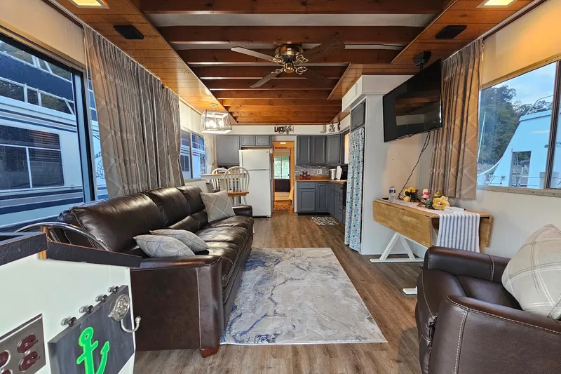 Slide: The Image of Interior of a 1985 Sumerset 14x60 houseboat with cozy living area and modern kitchen. - 6