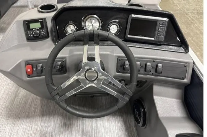 Slide: The Image of 2026 Bennington SSR boat dashboard with steering wheel, gauges, and electronic controls. - 3