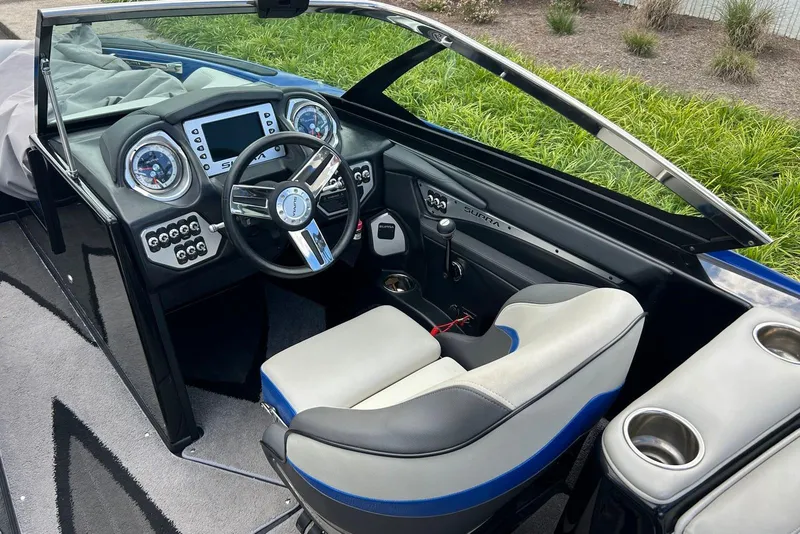 Slide: The Image of Interior of a 2014 Supra SA 450 boat with modern dashboard and steering wheel. - 12