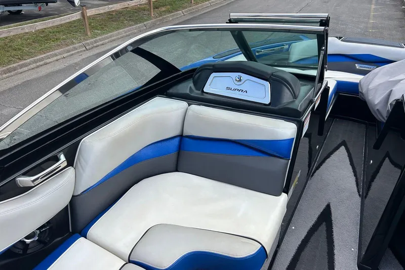 Slide: The Image of 2014 Supra SA 450 boat interior with blue and white seating, sleek design. - 13