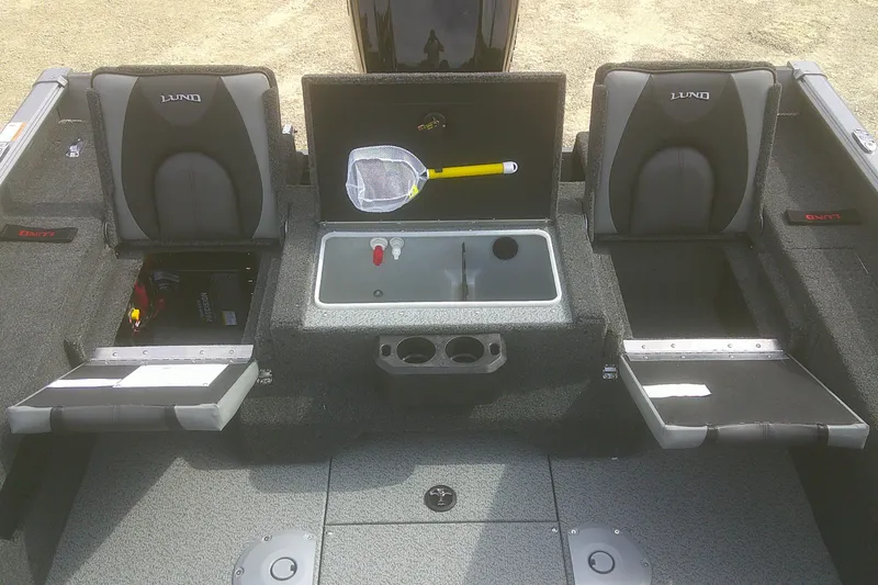 Slide: The Image of 2026 Lund 1775 Impact XS SS boat interior with storage compartments and seating. - 10