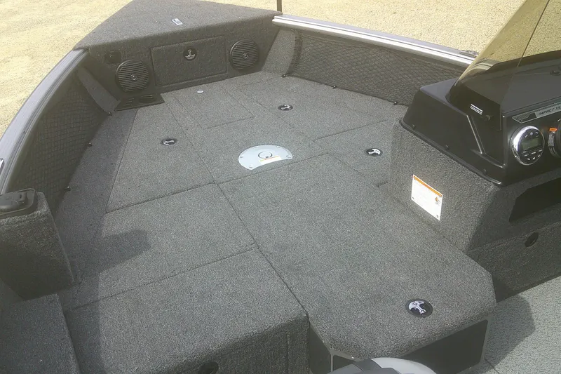 Slide: The Image of 2026 Lund 1775 Impact XS SS boat interior with carpeted deck and console. - 3