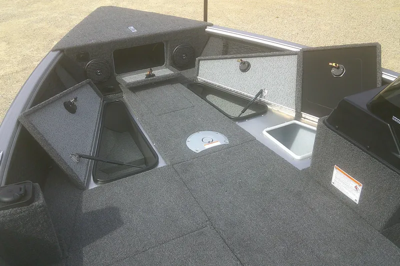 Slide: The Image of 2026 Lund 1775 Impact XS SS boat interior with open storage compartments. - 4