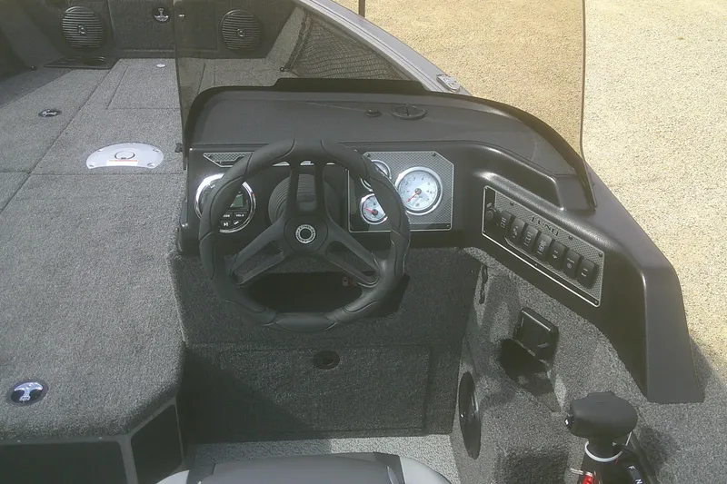 Slide: The Image of 2026 Lund 1775 Impact XS SS boat dashboard with steering wheel and control panel. - 6