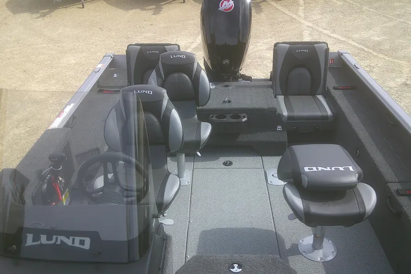 Slide: The Image of 2026 Lund 1775 Impact XS SS boat interior with seating and steering console. - 9