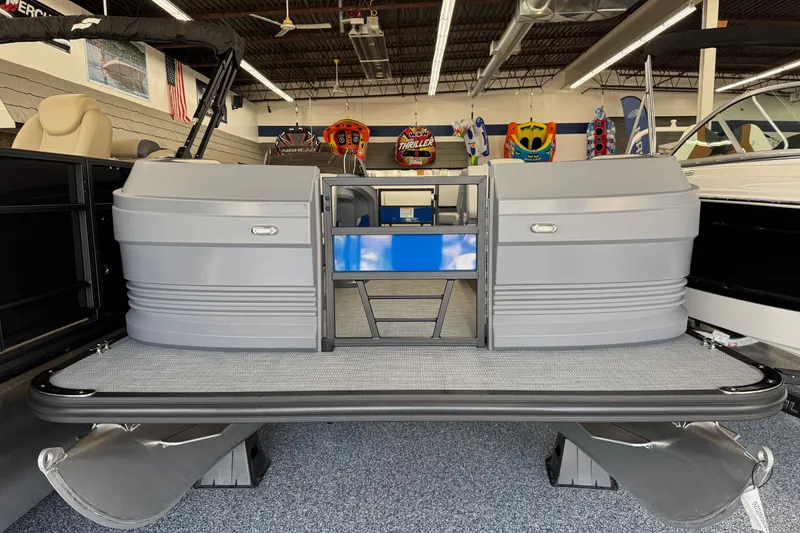 Slide: The Image of 2026 Starcraft GX 18 R pontoon boat displayed in showroom with modern design. - 2