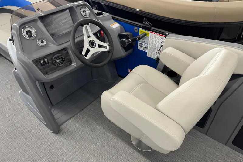 Slide: The Image of 2026 Starcraft GX 18 R boat cockpit with steering wheel and beige captain's chair. - 9