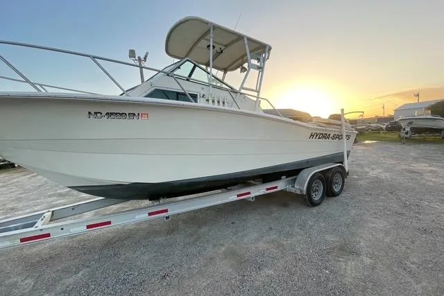 Slide: The Image of 1989 Hydra-Sports 2500WA boat on trailer at sunset, side view. - 0