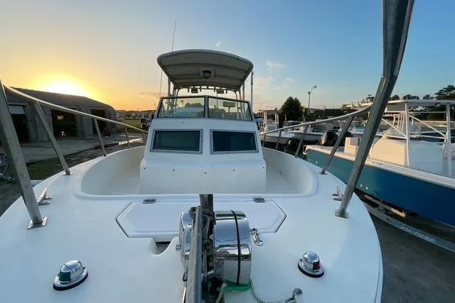 Slide: The Image of 1989 Hydra-Sports 2500WA boat at sunset, docked with clear sky background. - 11
