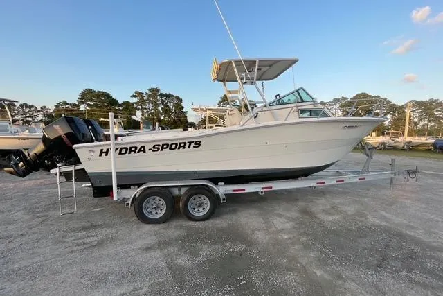 Slide: The Image of 1989 Hydra-Sports 2500WA boat on trailer, parked outdoors under clear sky. - 2