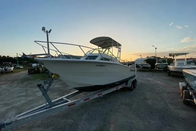 Slide: The Image of 1989 Hydra-Sports 2500WA boat on trailer at sunset, parked in a lot. - 5