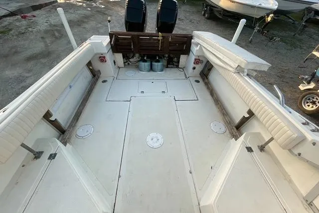 Slide: The Image of 1989 Hydra-Sports 2500WA boat interior with spacious seating and dual outboard engines. - 6