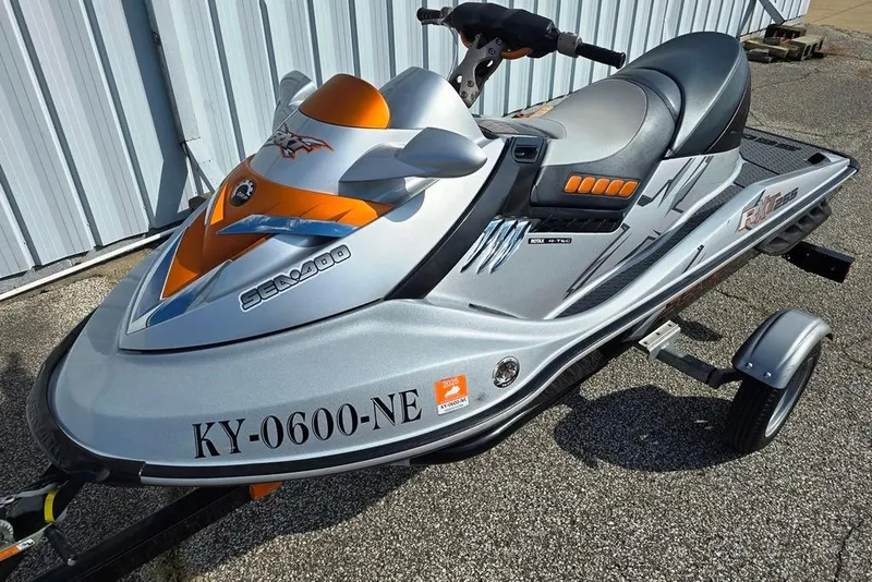 The Image of 2009 Sea-Doo RXT 255 jet ski on trailer, silver and orange design. - 0