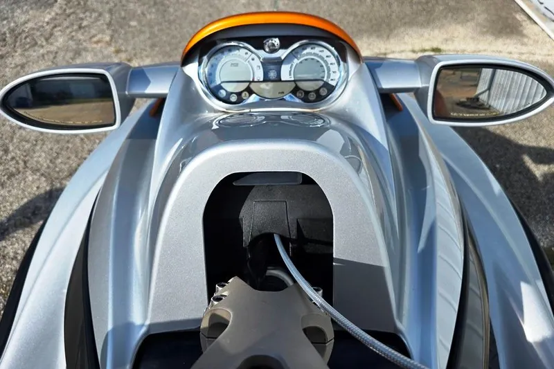 Slide: The Image of 2009 Sea-Doo RXT 255 dashboard with mirrors and gauges, silver and orange design. - 3