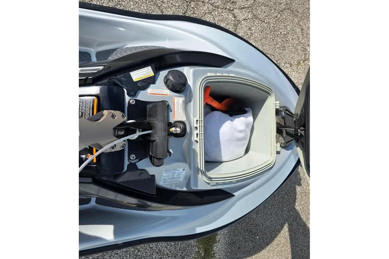 Slide: The Image of 2009 Sea-Doo RXT 255 storage compartment with items inside, open on a sunny day. - 6