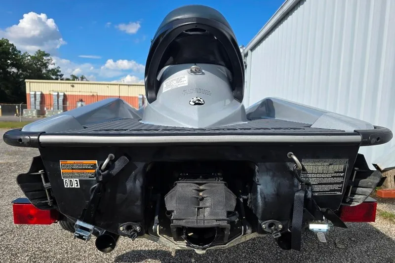 Slide: The Image of 2009 Sea-Doo RXT 255 jet ski rear view, parked outdoors near a building. - 8