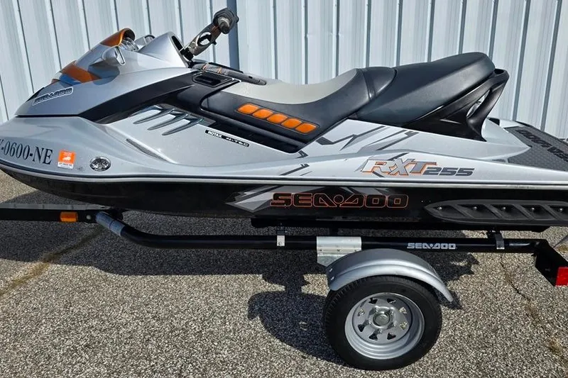 Slide: The Image of 2009 Sea-Doo RXT 255 jet ski on trailer, parked near a metal building. - 9