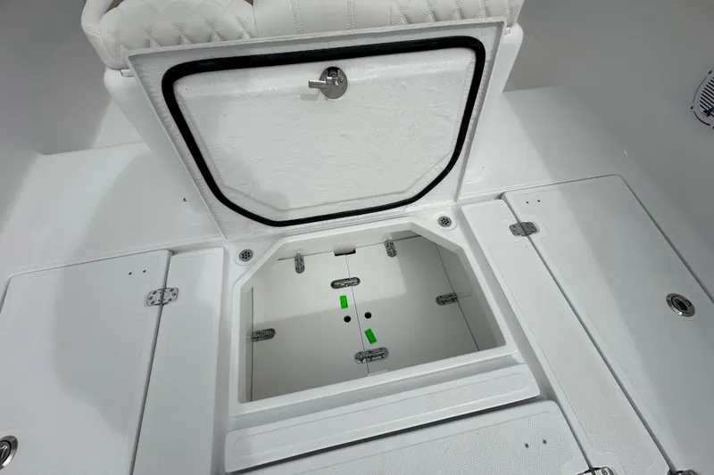 Slide: The Image of Open storage compartment on 2026 Bluewater 2850 boat, featuring white interior and secure latch. - 10
