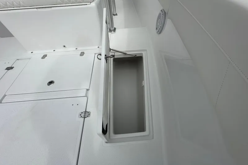 Slide: The Image of 2026 Bluewater 2850 boat storage compartment with open hatch, showcasing sleek white interior design. - 11