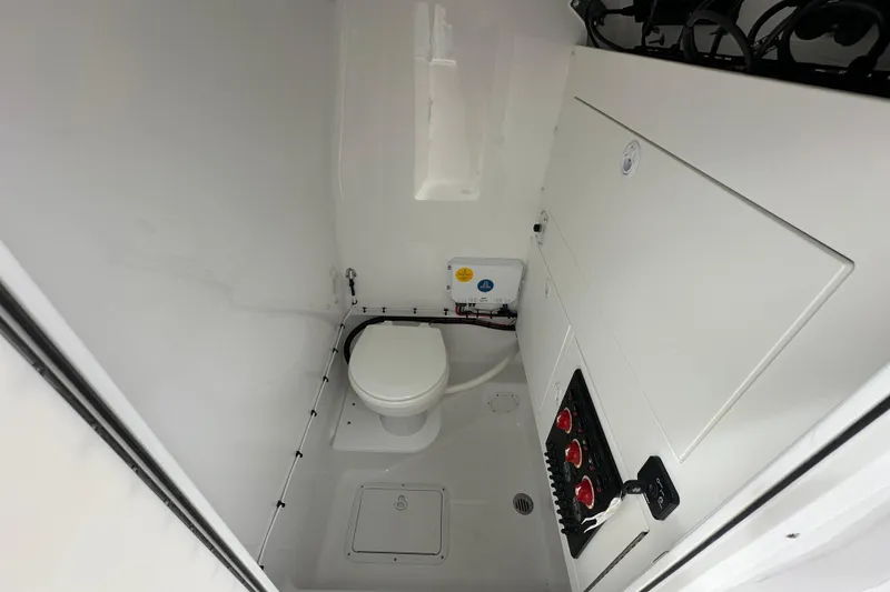 Slide: The Image of Interior of 2026 Bluewater 2850 boat bathroom with toilet and control panel. - 15
