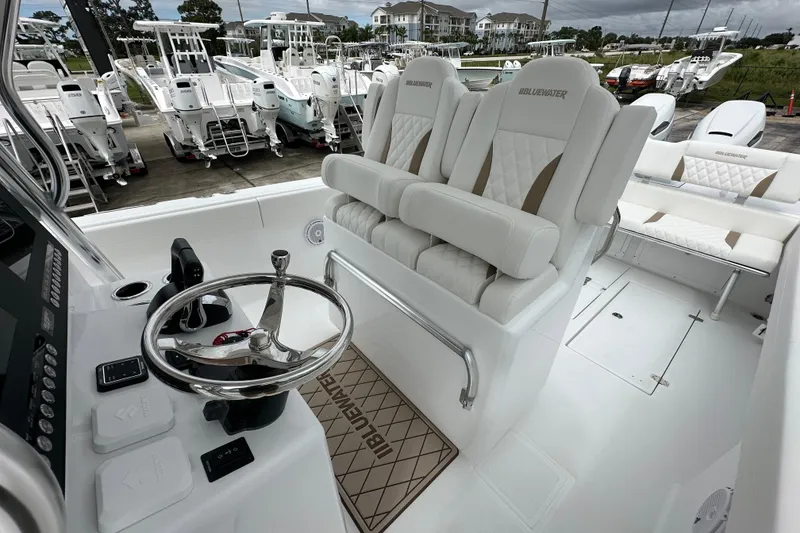 Slide: The Image of Interior of 2026 Bluewater 2850 boat with luxurious seating and steering wheel. - 16