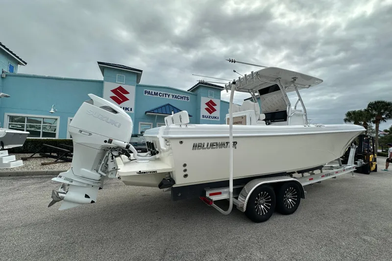 Slide: The Image of 2026 Bluewater 2850 boat on trailer at Palm City Yachts dealership. - 2