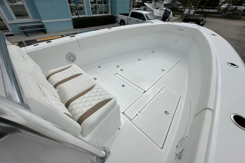 Slide: The Image of 2026 Bluewater 2850 boat interior with white seating and storage compartments. - 8
